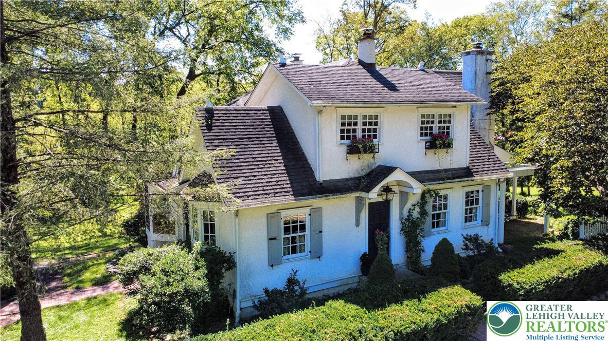 1731 Howell Road Easton, PA 18040 - Photo 2 of 60 Mature trees frame a classic two-story exterior featuring shuttered windows and dual chimneys.