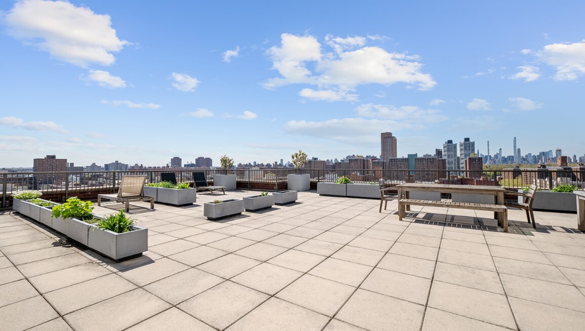 1485 5th Avenue, Unit 13A Manhattan, NY 10035 - Photo 12 of 16 a view of a terrace with furniture and a fire pit