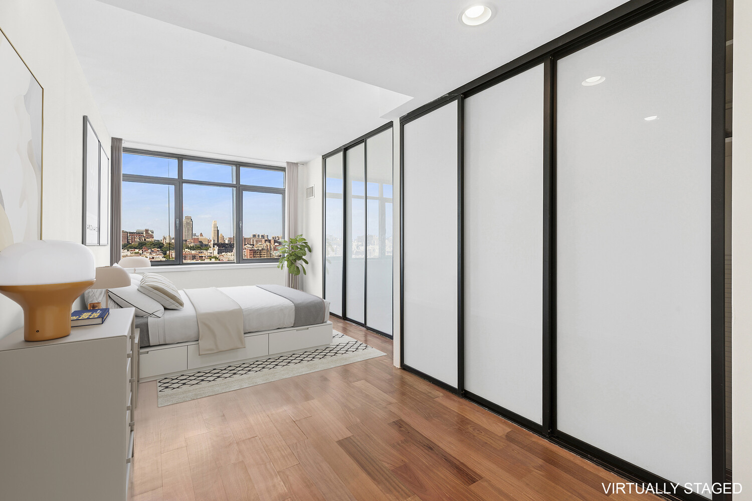 1485 5th Avenue, Unit 13A Manhattan, NY 10035 - Photo 4 of 16 a living room with furniture and a large window
