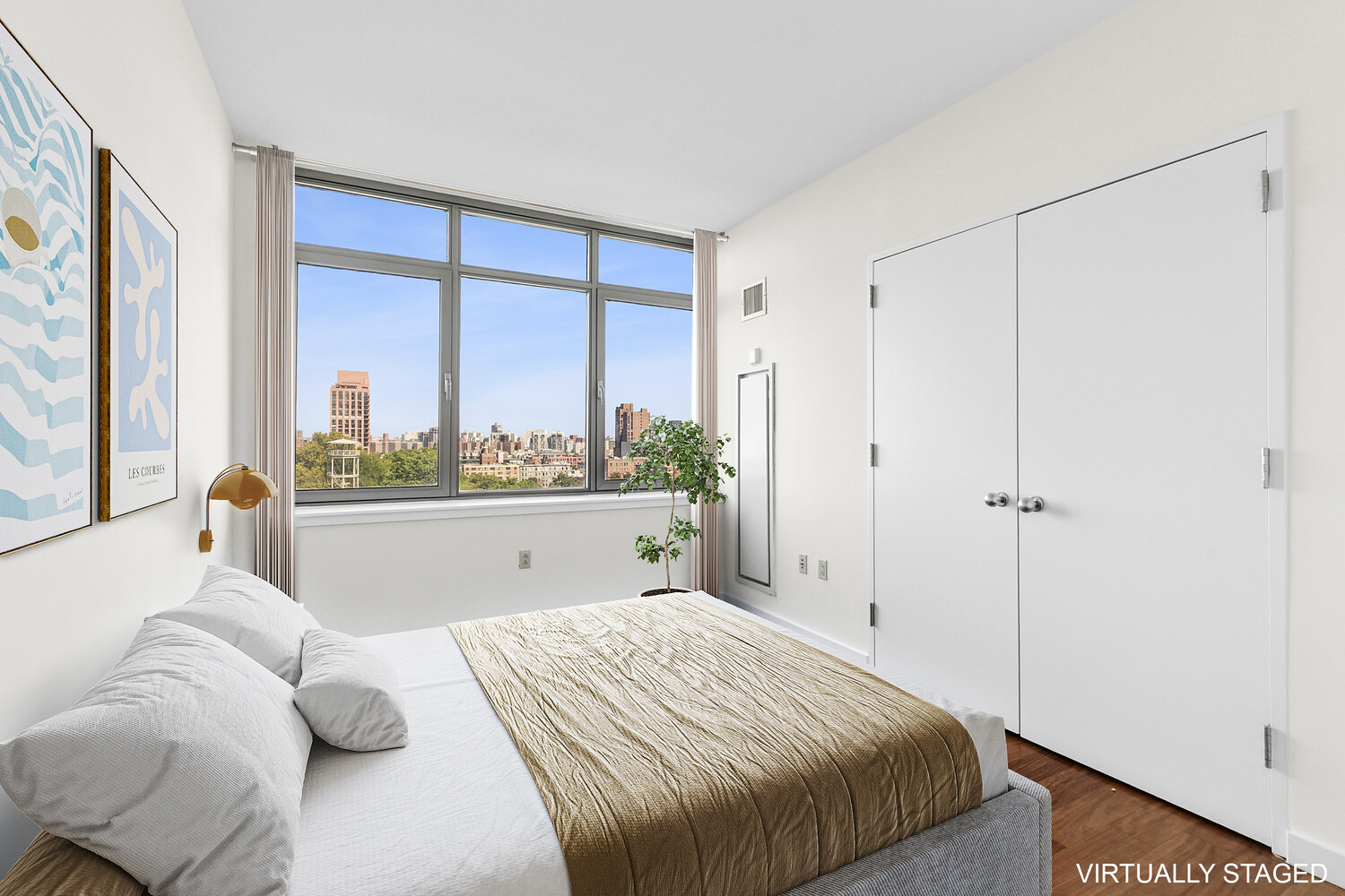 1485 5th Avenue, Unit 13A Manhattan, NY 10035 - Photo 5 of 16 a bedroom with a large bed and a large window