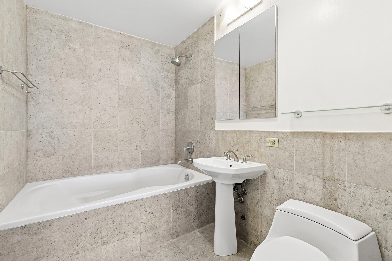 1485 5th Avenue, Unit 13A Manhattan, NY 10035 - Photo 8 of 16 a bathroom with a sink a toilet and shower