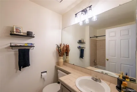 a bathroom with a sink a toilet and mirror