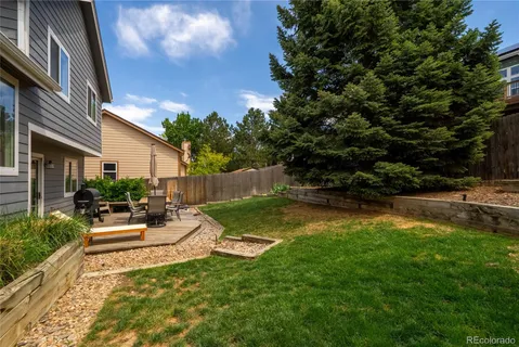 a view of backyard of house with green space