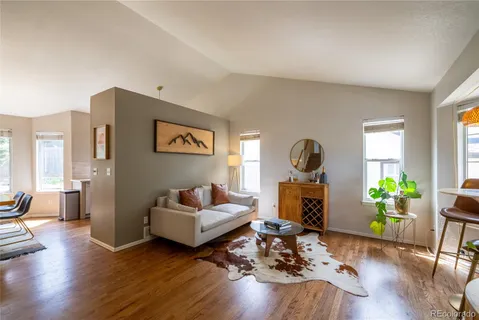 a living room with furniture and wooden floor
