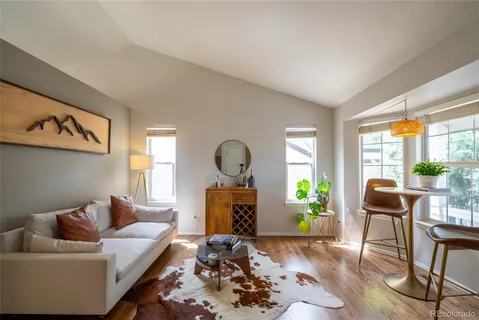 a living room with furniture a window and a fireplace