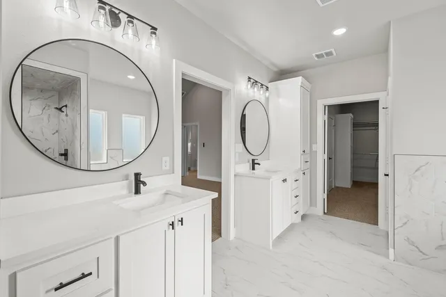 a bathroom with a sink a mirror a vanity and a mirror