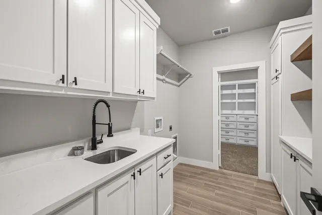 a kitchen with a sink cabinets and appliances