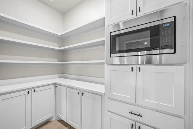 a large kitchen with stainless steel appliances a large counter space a sink and cabinets