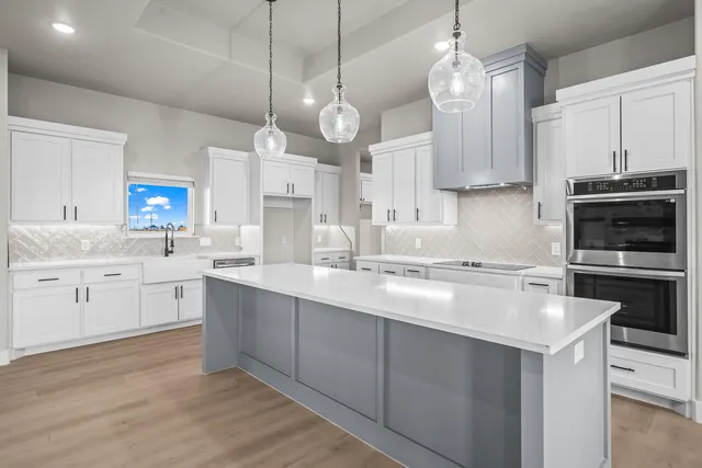 a large kitchen with kitchen island a sink stainless steel appliances and cabinets