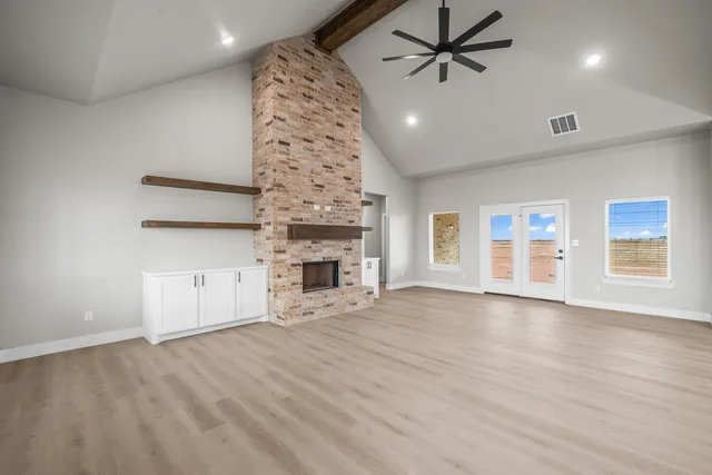 a view of an empty room with a kitchen