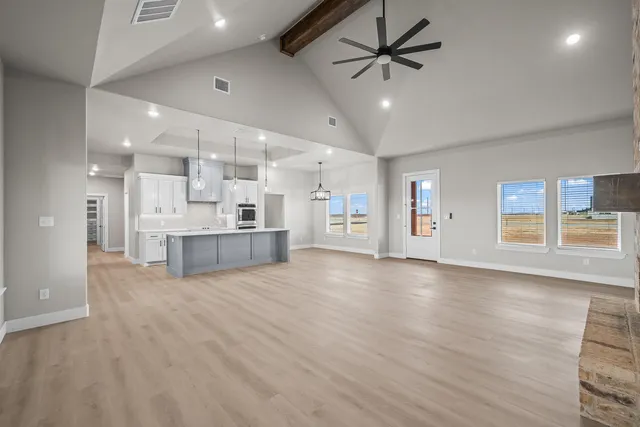 an empty room with a window and a fan