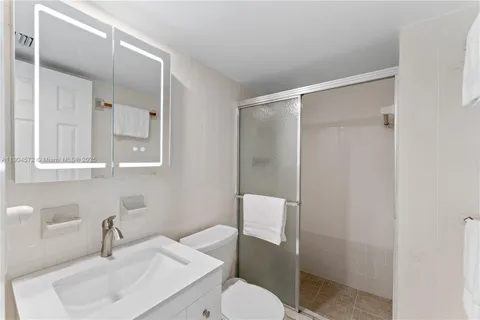 a bathroom with a toilet a sink and shower