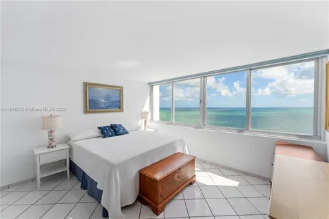 a bedroom with a bed and a television