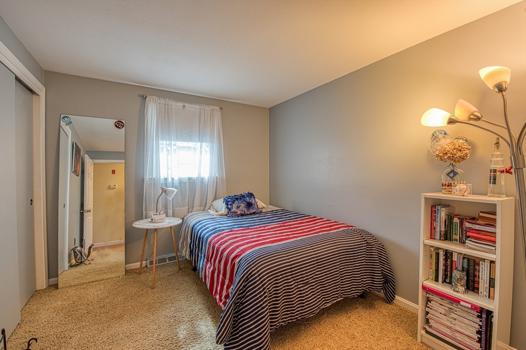 10 Colby Road Bridgewater, MA 02324 - Photo 25 of 42 a bedroom with a bed and a bookshelf with wooden floor