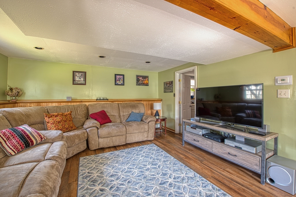10 Colby Road Bridgewater, MA 02324 - Photo 37 of 42 a living room with furniture and a flat screen tv