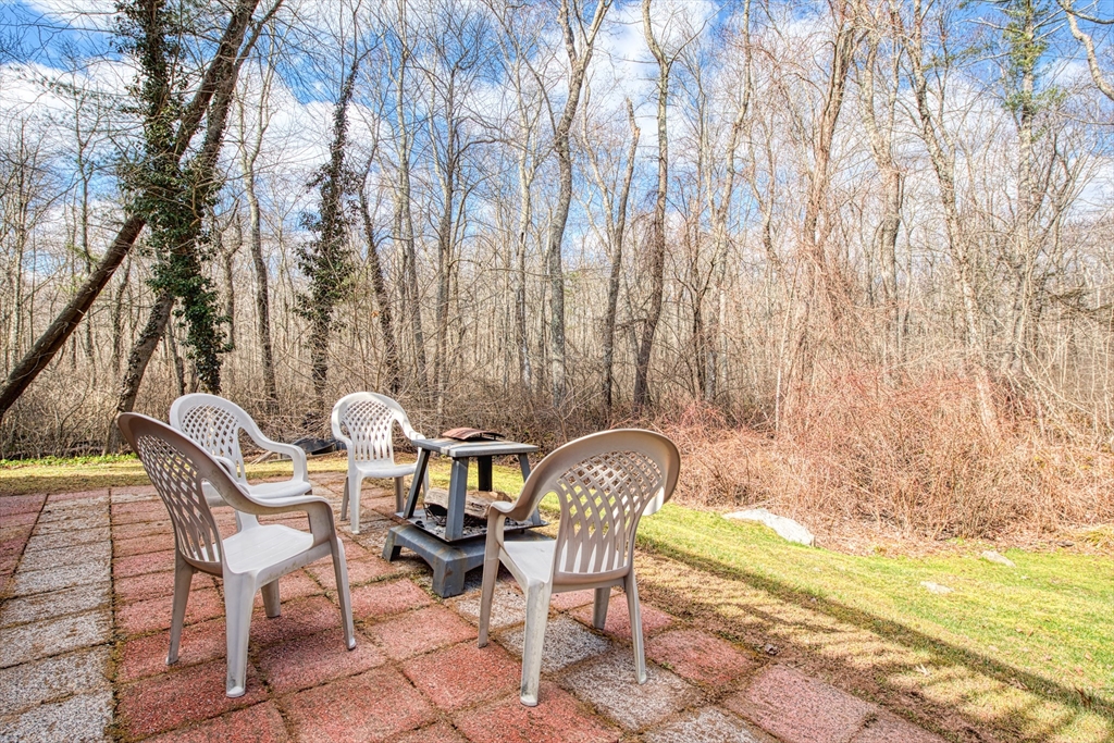 10 Colby Road Bridgewater, MA 02324 - Photo 9 of 42 a wooden bench sitting in a backyard