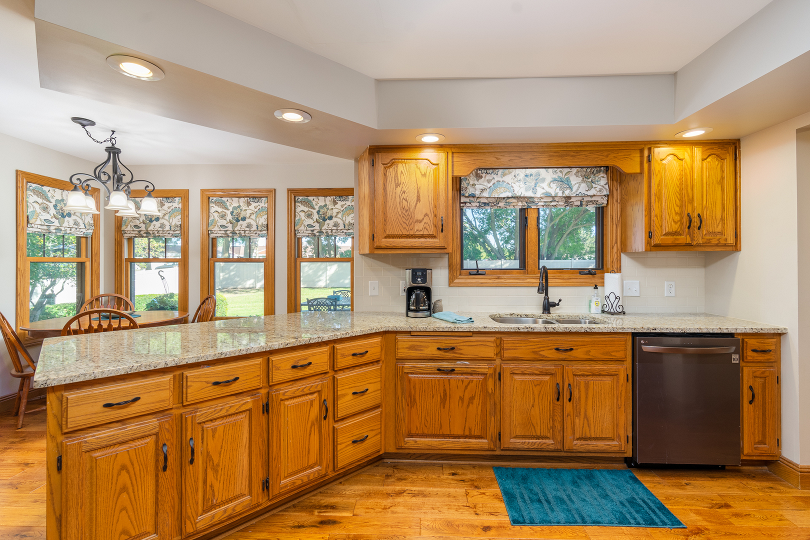 100 Willow Trail Spring Valley, IL 61362 - Photo 15 of 57 a large kitchen with kitchen island granite countertop a sink and dishwasher wooden cabinets with a large window