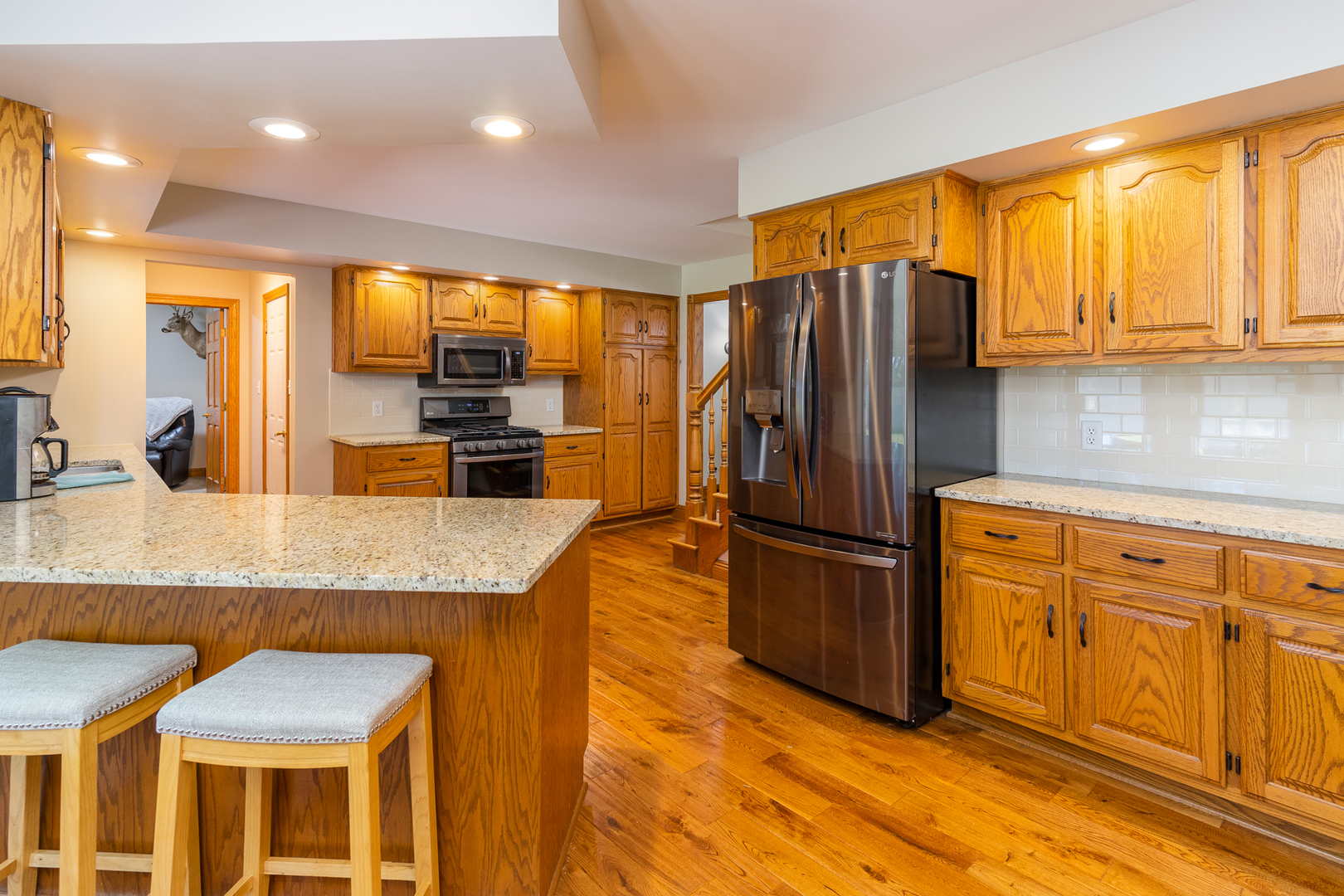 100 Willow Trail Spring Valley, IL 61362 - Photo 17 of 57 a kitchen with stainless steel appliances granite countertop a refrigerator a stove and a sink with wooden floors