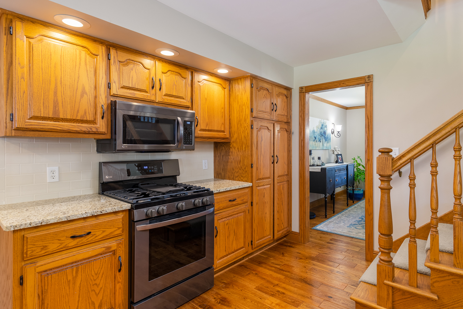100 Willow Trail Spring Valley, IL 61362 - Photo 18 of 57 a kitchen with stainless steel appliances granite countertop a stove top oven a refrigerator a sink and dishwasher with wooden floor