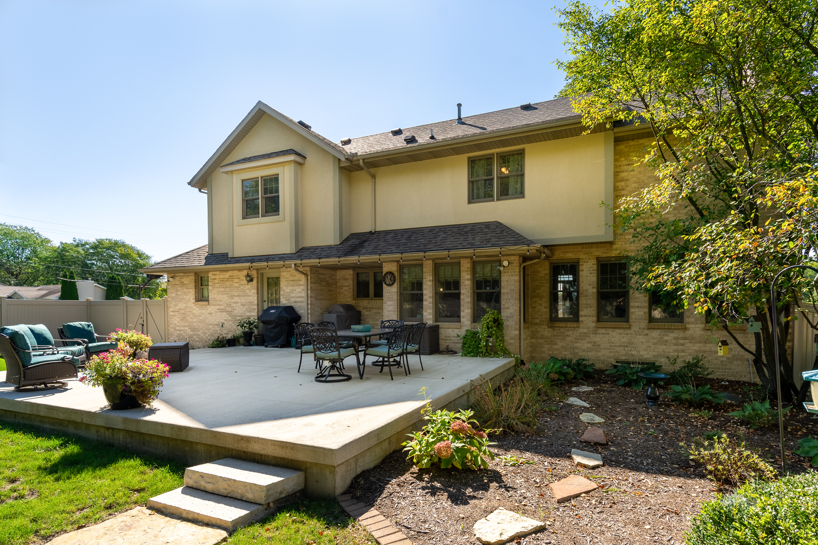 100 Willow Trail Spring Valley, IL 61362 - Photo 40 of 57 a view of a patio with table and chairs potted plants and a large tree
