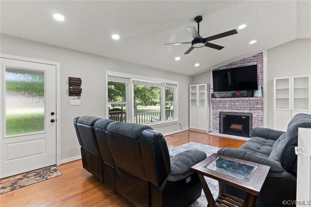 3315 Three Chopt Road Gum Spring, VA 23065 - Photo 5 of 27 a living room with furniture a flat screen tv and a fireplace