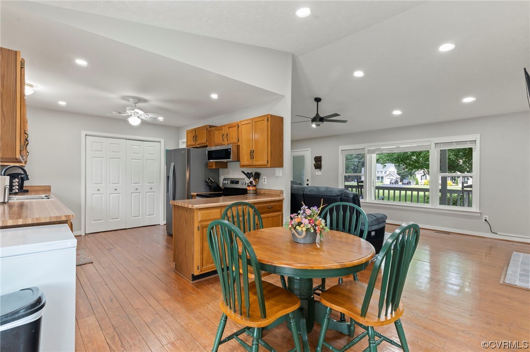 3315 Three Chopt Road Gum Spring, VA 23065 - Photo 9 of 27 a kitchen with stainless steel appliances kitchen island granite countertop a dining table chairs and refrigerator