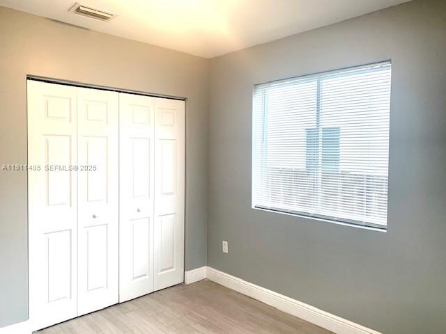 4126 Northwest 3rd Avenue, Unit 4126 Miami, FL 33127 - Photo 17 of 29 a view of an empty room with wooden floor and a window