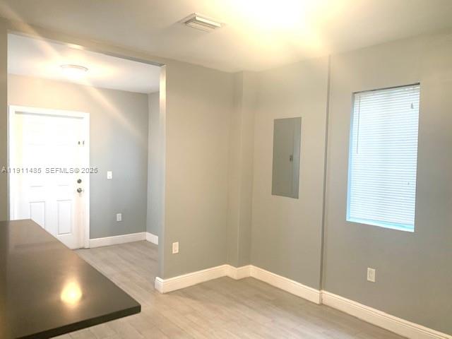 4126 Northwest 3rd Avenue, Unit 4126 Miami, FL 33127 - Photo 21 of 29 a view of a livingroom with wooden floor and a bathroom space
