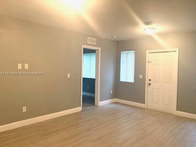 4126 Northwest 3rd Avenue, Unit 4126 Miami, FL 33127 - Photo 4 of 29 wooden floor in an empty room