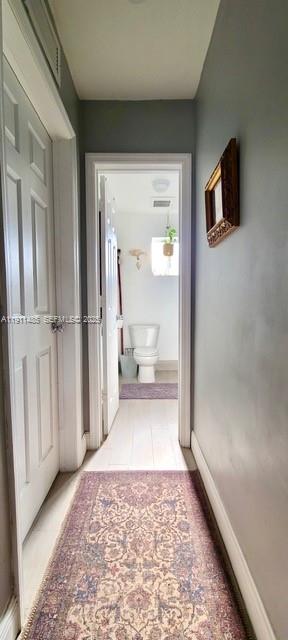4126 Northwest 3rd Avenue, Unit 4126 Miami, FL 33127 - Photo 6 of 29 a view of a hallway with wooden floor and a bathroom