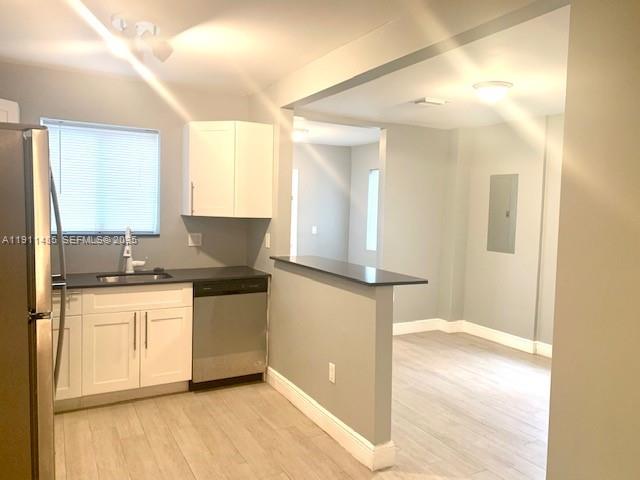 4126 Northwest 3rd Avenue, Unit 4126 Miami, FL 33127 - Photo 7 of 29 a kitchen with stainless steel appliances granite countertop a stove a sink and a refrigerator
