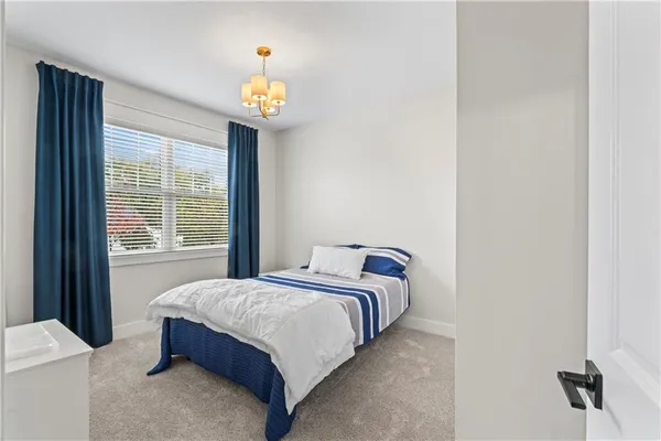 a bedroom with a bed and a chandelier