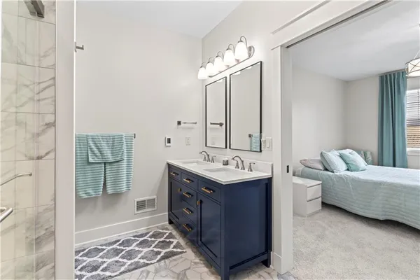 a bathroom with a double vanity sink mirror and bathtub
