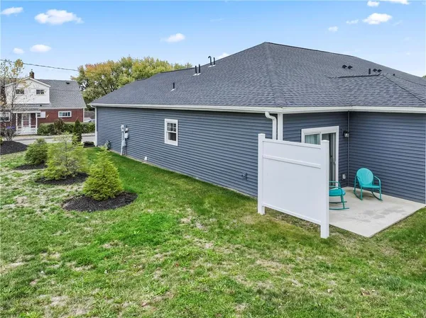 a view of backyard of house with green space