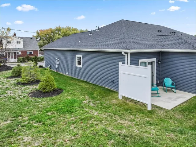 a view of backyard of house with green space