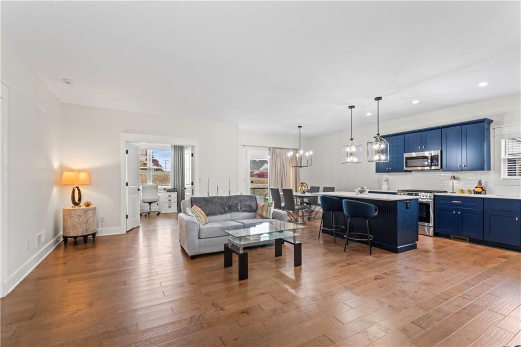 16 Barrington Court Monaca, PA 15061 - Photo 3 of 36 a large living room with stainless steel appliances kitchen island granite countertop lots of furniture and a wooden floors