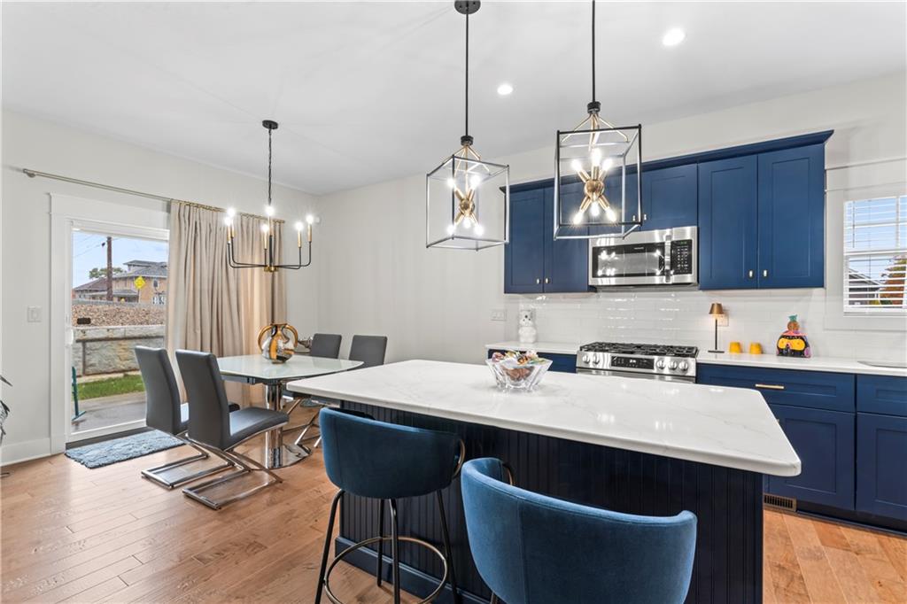 16 Barrington Court Monaca, PA 15061 - Photo 5 of 36 a kitchen with a dining table chairs and wooden floor