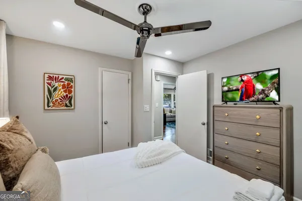 a bedroom with a bed and a flat screen tv