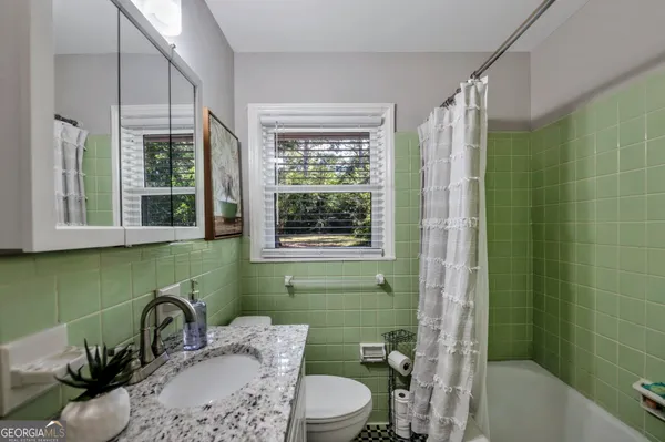 a bathroom with a sink toilet and tub