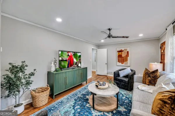a living room with furniture and a flat screen tv