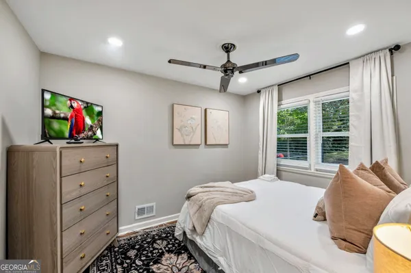 a bedroom with a bed and a flat screen tv