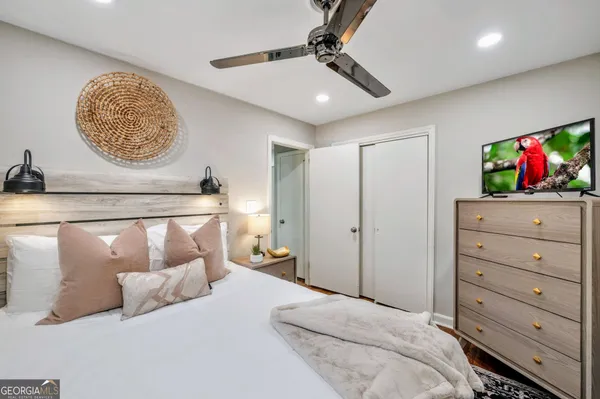 a bedroom with a bed and a flat screen tv