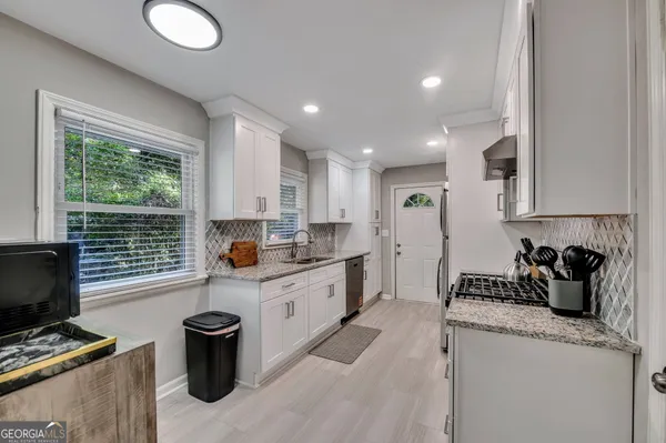 a kitchen with sink refrigerator and window