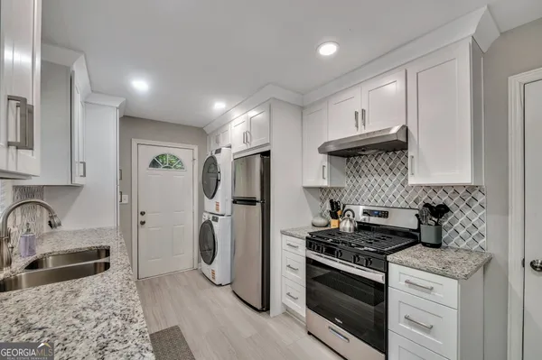 a kitchen with a refrigerator and a sink