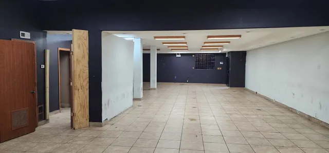 a view of a room with gym equipment and large windows