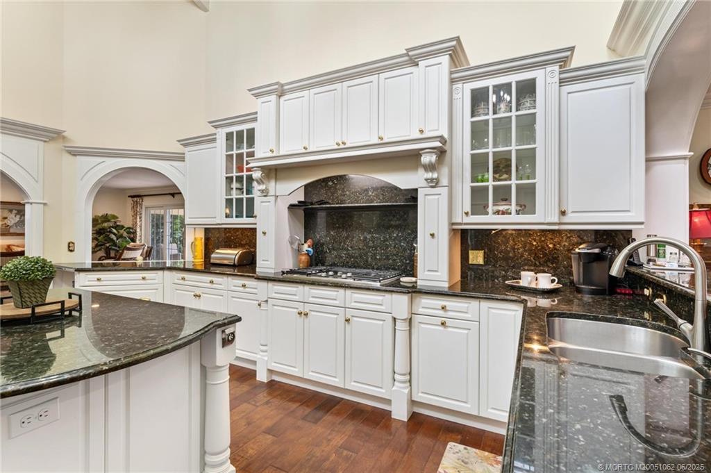 3192 Southeast Fairway West Stuart, FL 34997 - Photo 17 of 76 a kitchen with granite countertop a sink stainless steel appliances and cabinets