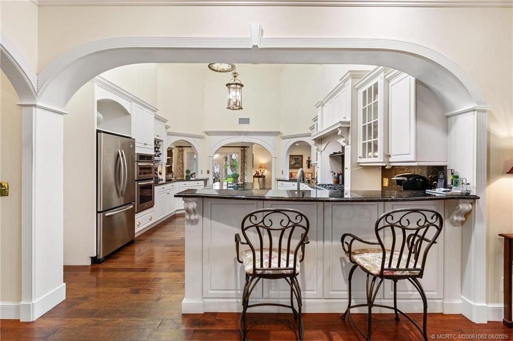 3192 Southeast Fairway West Stuart, FL 34997 - Photo 20 of 76 a view of a kitchen with furniture and wooden floor