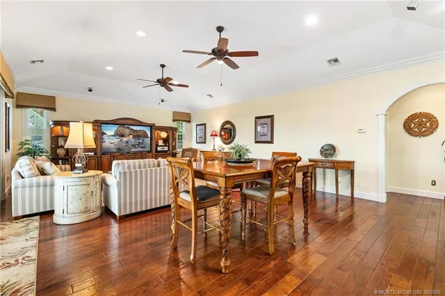 a living room with furniture ceiling fan and a rug