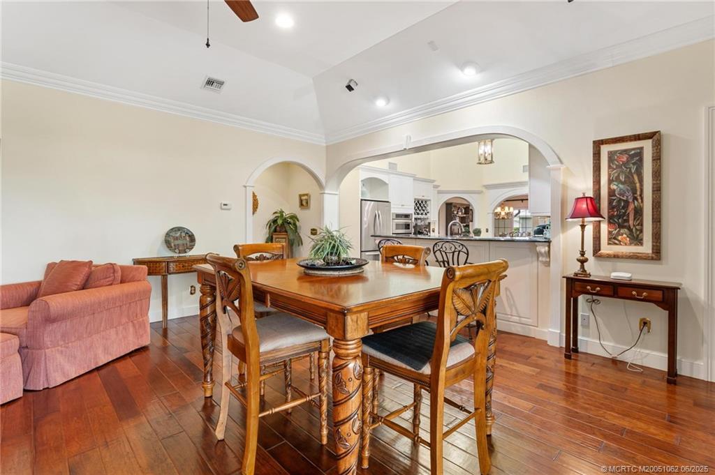 3192 Southeast Fairway West Stuart, FL 34997 - Photo 24 of 76 a view of a dining room with furniture and wooden floor