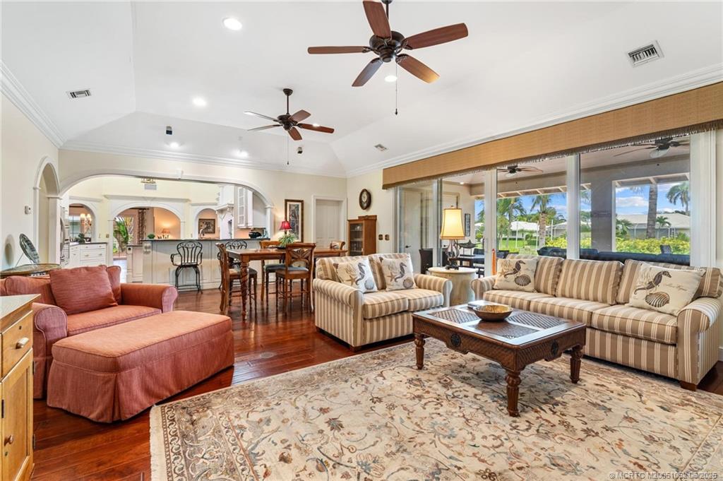 3192 Southeast Fairway West Stuart, FL 34997 - Photo 27 of 76 a living room with furniture ceiling fan and a rug
